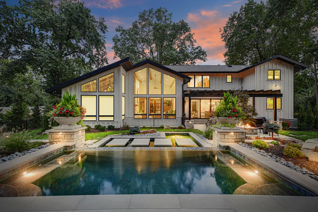 Pool at twilight in front of a modern home