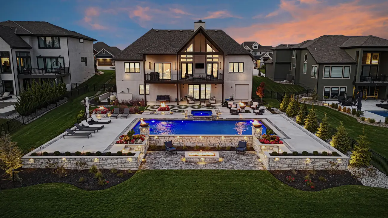 Pool and raised spa lit at twilight