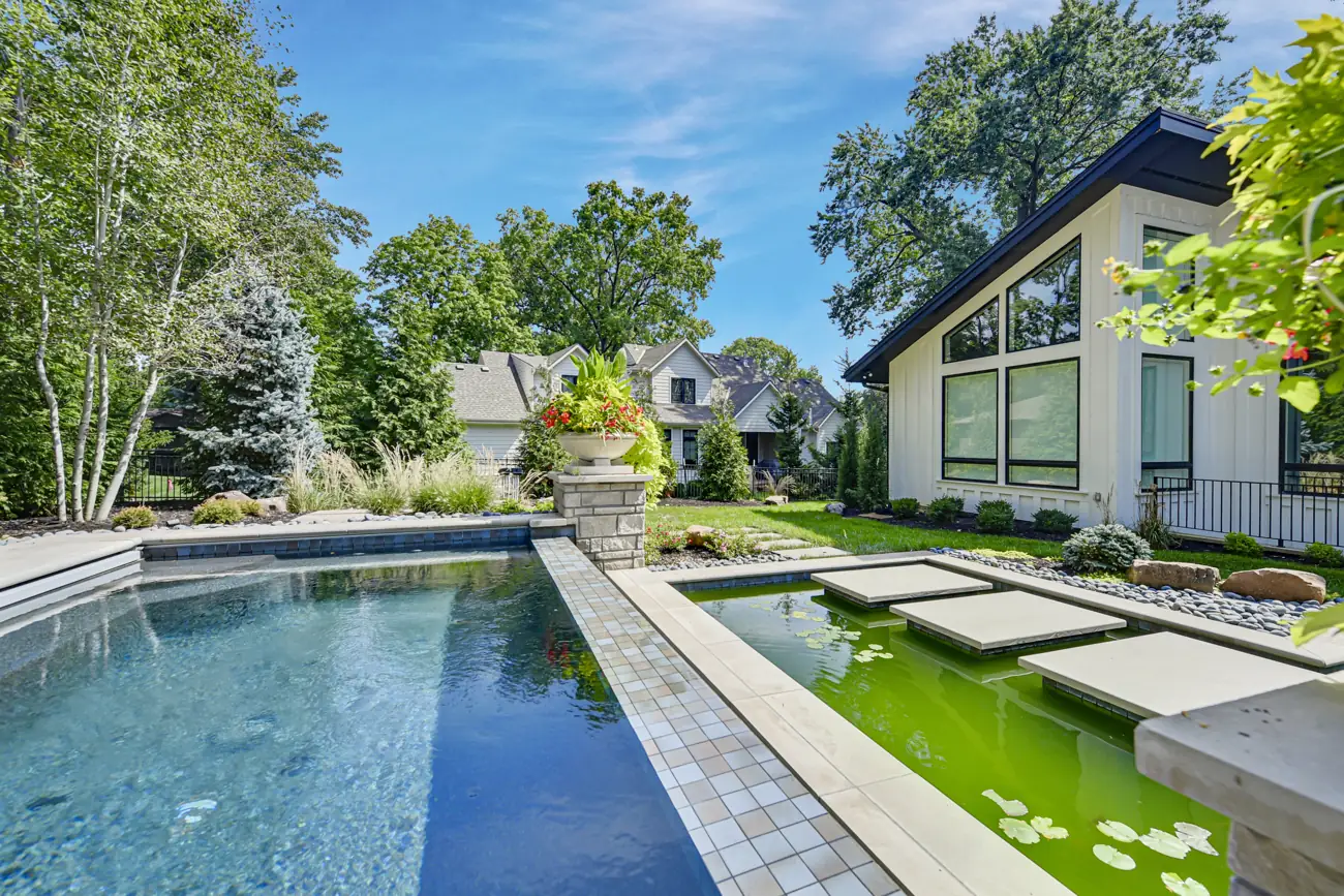 Pool alongside a planted water garden with stepping stones